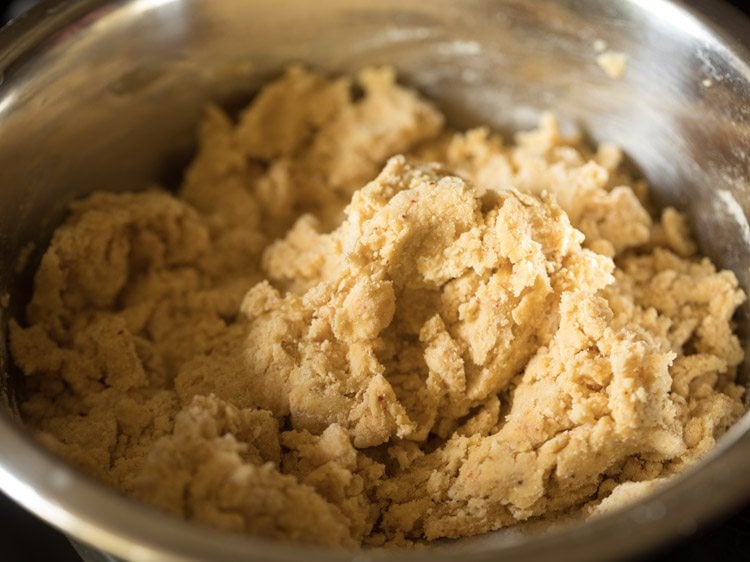 kneading the mixture into a dough for making ribbon murukku. 