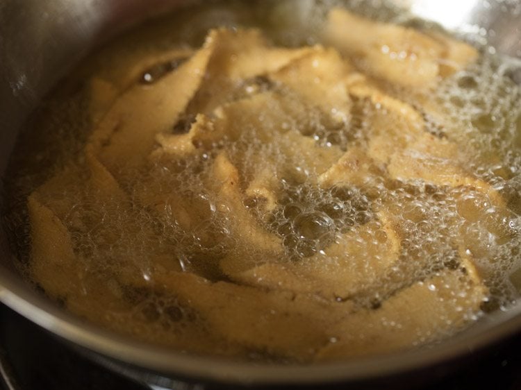 frying ribbon pakodas from the other side as well. 