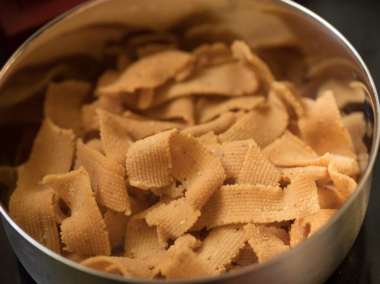 ribbon pakoda placed in a steel container. 