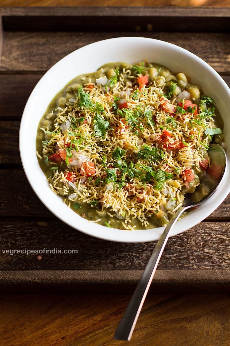 masala puri served in a white bowl with a spoon