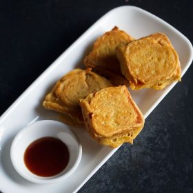 potato bread pattice served on a white platter with a small bowl of sweet date-tamarind chutney kept on the left side and text layovers.