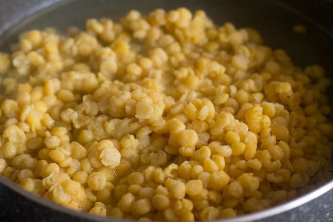 cooked chana dal with its water added to another pan.