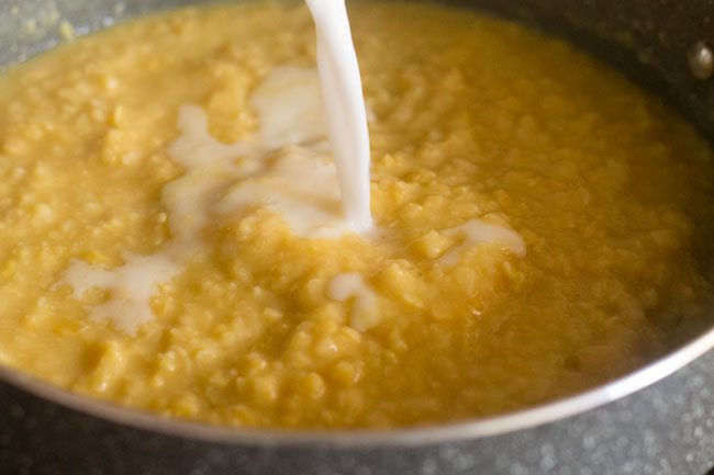 adding thin coconut milk to the mashed chana dal.