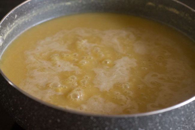heating sweetened chana dal-coconut milk mixture.