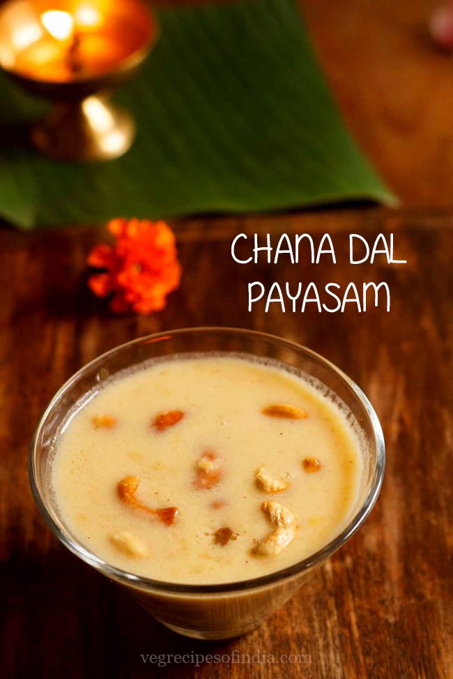chana dal payasam garnished with fried cashews and served in a glass bowl with text layover.