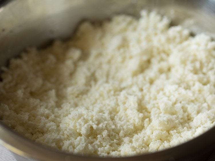 fresh paneer or chenna crumbled well in a bowl for making chenna poda. 