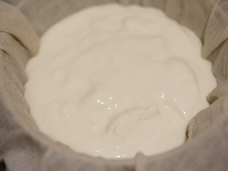 cotton napkin on the strainer and fresh curd