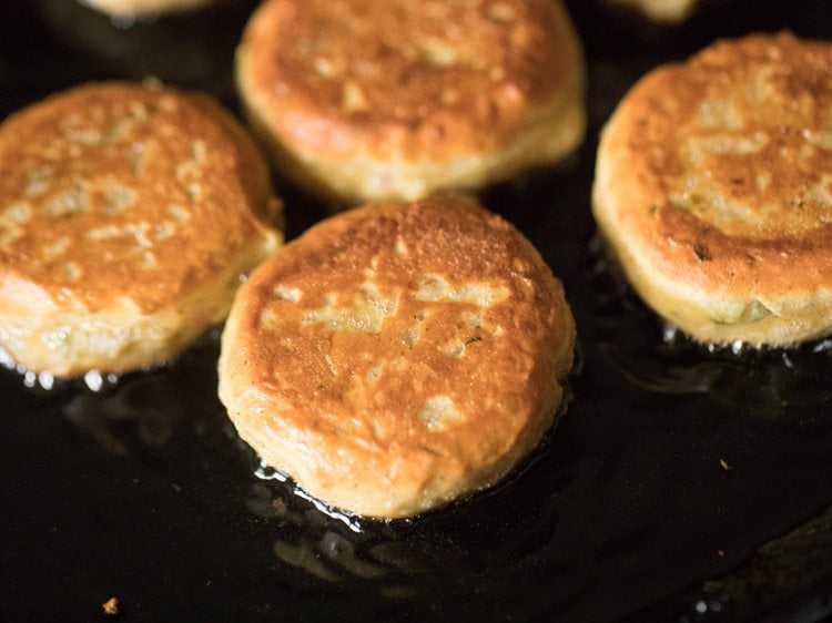 golden dahi kabab frying in a pan