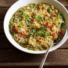 masala puri served in a white bowl with a spoon