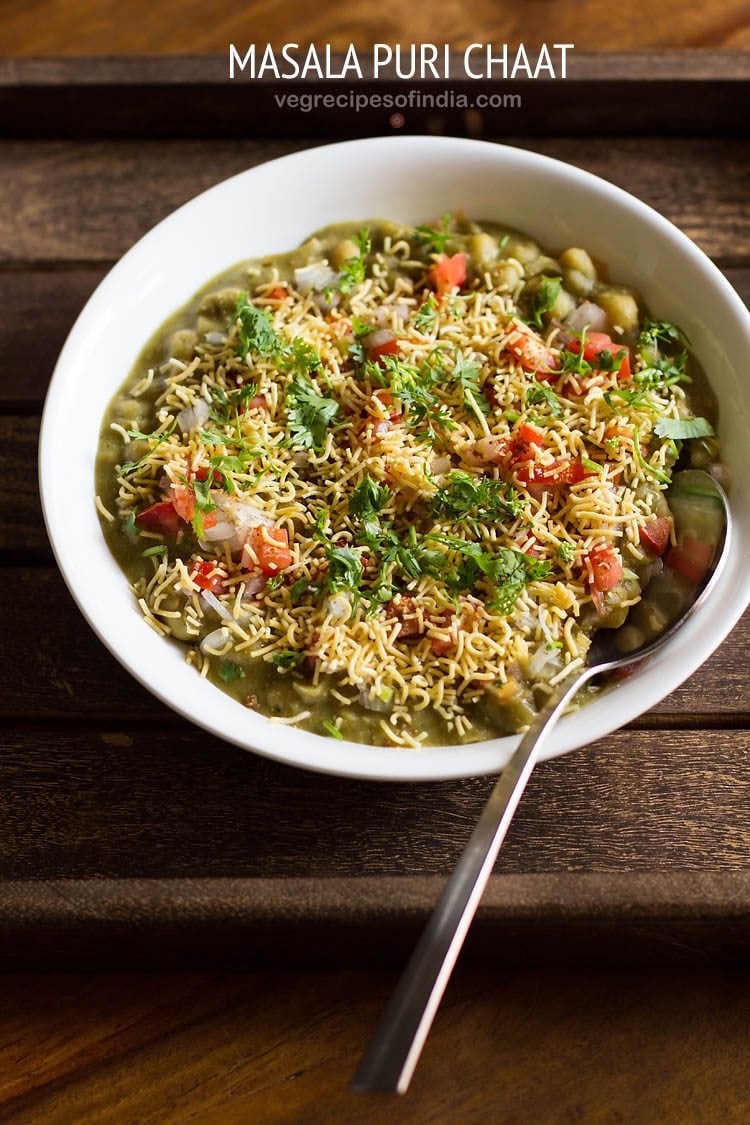 masala puri served in a white bowl with a spoon