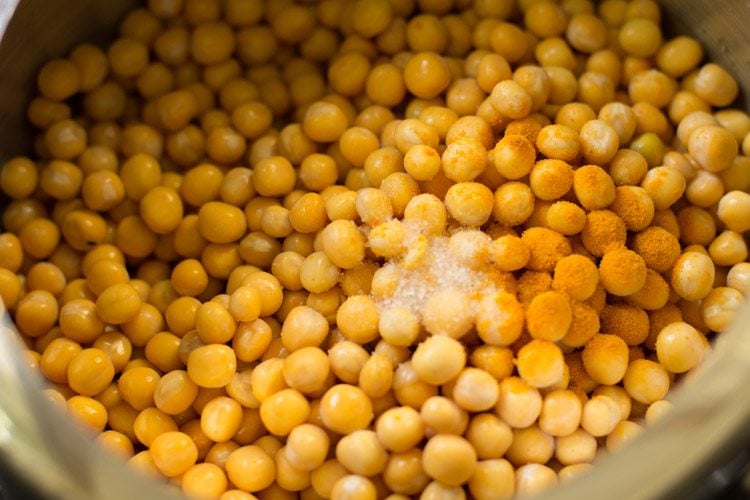 white peas in a pressure cooker with salt and turmeric