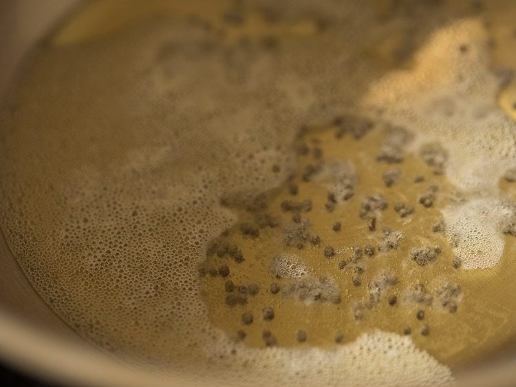 crackling mustard seeds in the hot oil in pan. 