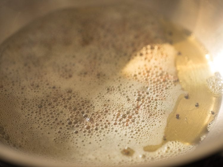 frying fenugreek seeds in the pan. 