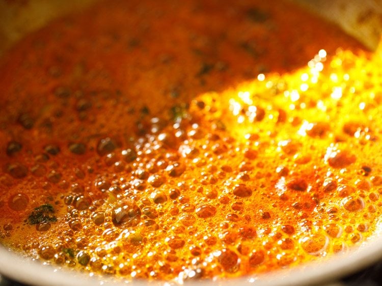 frying spice powders in the pan. 