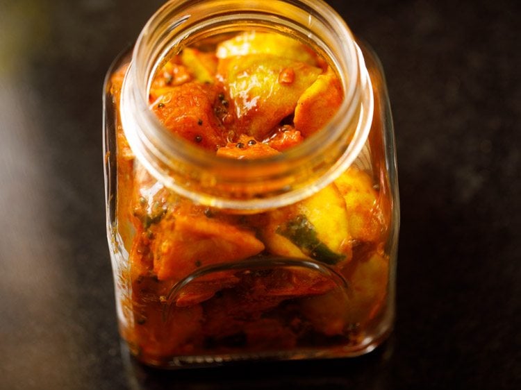 naranga achar spooned in a glass jar. 