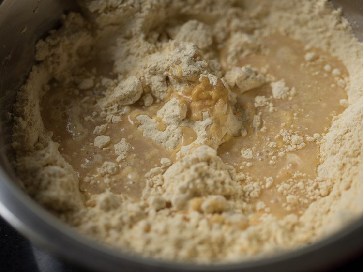 adding water in parts to the flour mixture. 