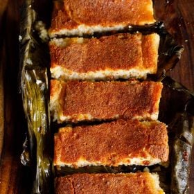 chhena poda sliced thickly and served in a banana leaf.