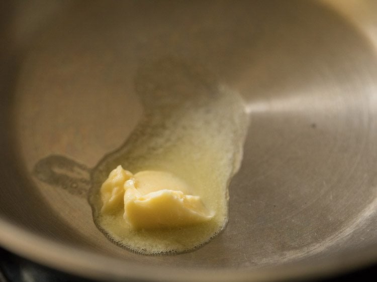 heating butter in a pan. 