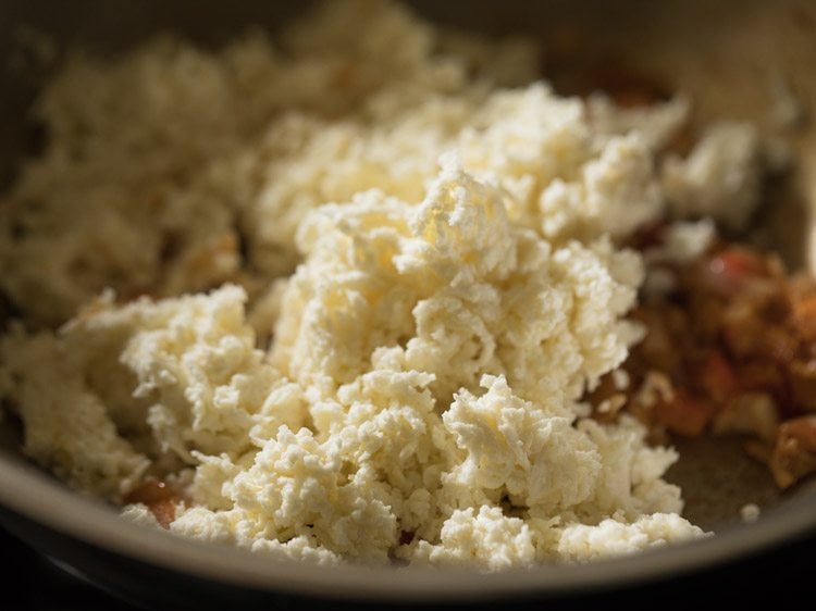 grated paneer added to the spiced onion mixture. 