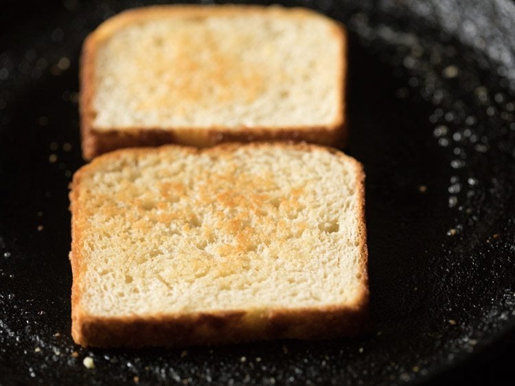 lightly toasting the bread slices. 