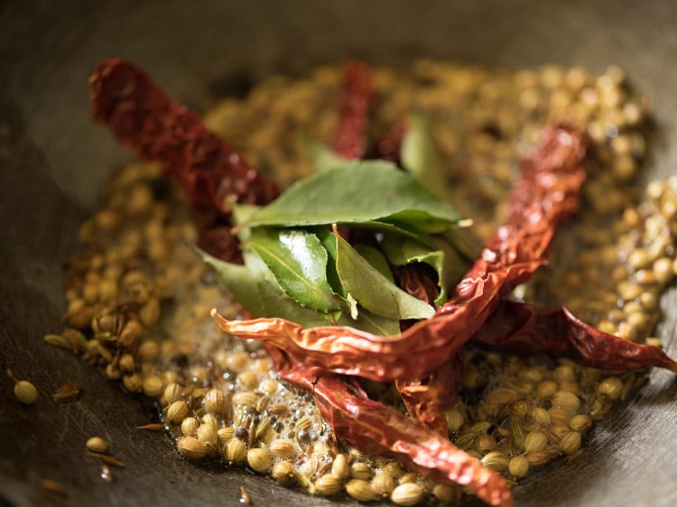 dried red chilies and curry leaves added to the pan. 