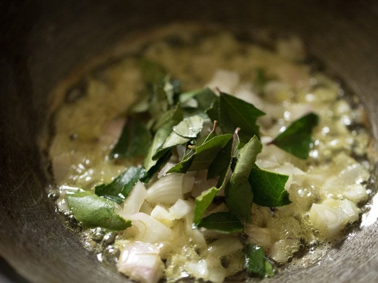 chopped onions and curry leaves added to the pan. 