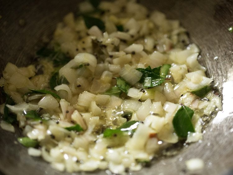 sautéing onions with the other ingredients for paneer gassi recipe. 