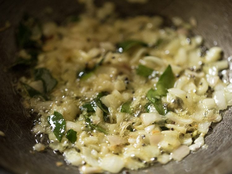 sautéing onions with the other ingredients for paneer gassi recipe. 