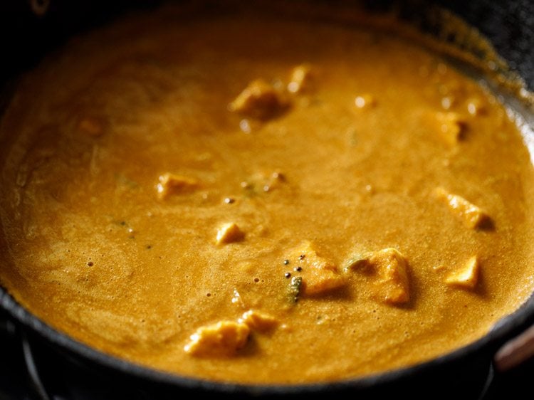 cubed paneer mixed well in the simmering gravy. 