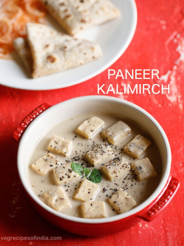 paneer kali mirch garnished with mint leaves and crushed black pepper and served in a red ceramic casserole with a plate of chapattis kept on the top left side and text layovers.