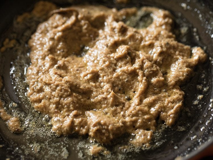 sautéing onion paste with crushed pepper. 