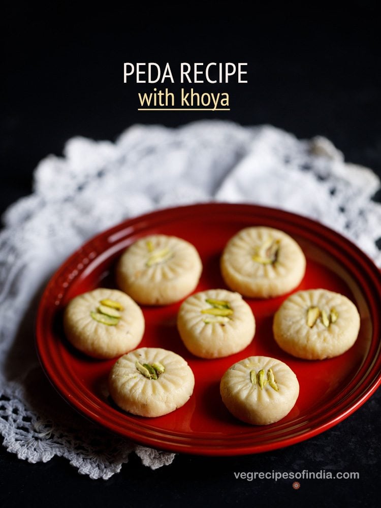 7 peda pieces on a red plate placed on white doilies.