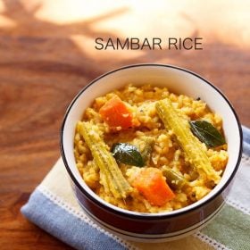 sambar rice served in a black rimmed ceramic bowl with text layovers.