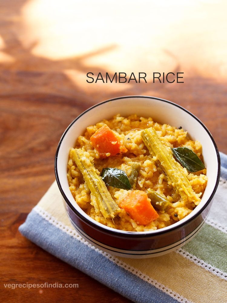 sambar rice served in a black rimmed ceramic bowl with text layovers.