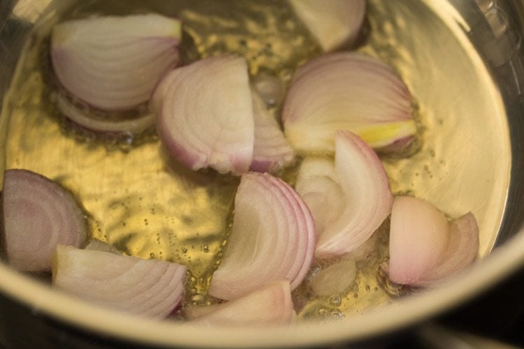 thickly sliced onions added to hot sesame oil. 