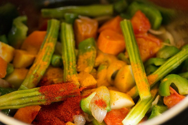 turmeric powder and kashmiri red chili powder added to the vegetables. 