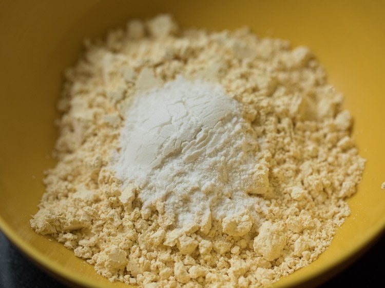 gram flour and rice flour added to another mixing bowl for boondi batter. 