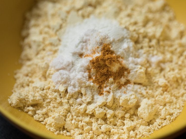 asafoetida, baking soda, turmeric powder and salt added to the bowl. 