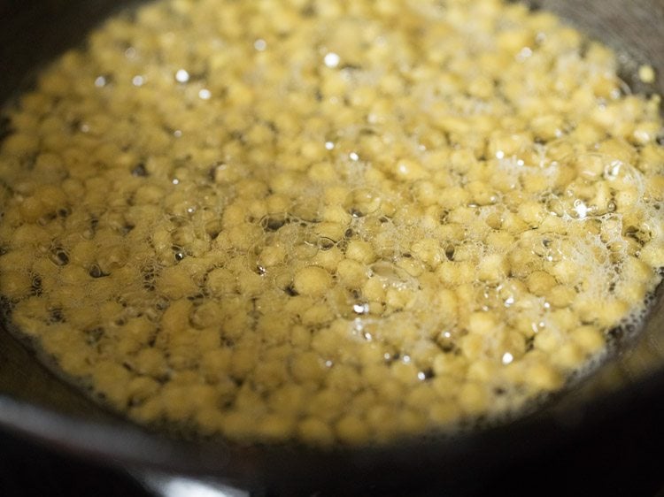 frying boondi in hot oil for south indian mixture recipe. 