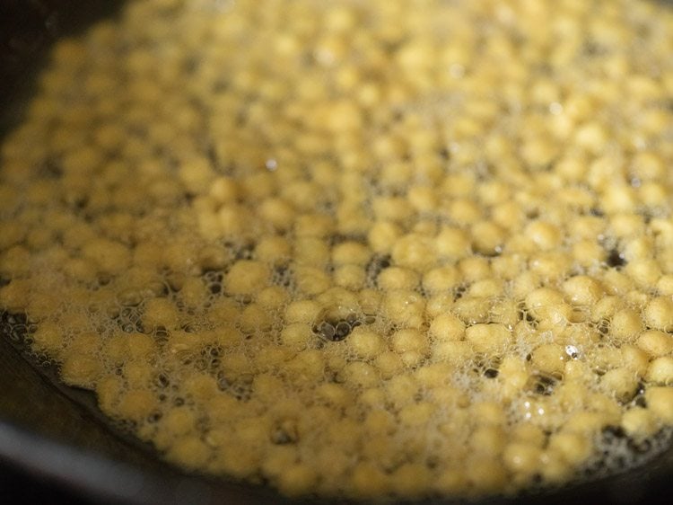 frying boondi in hot oil for south indian mixture recipe. 