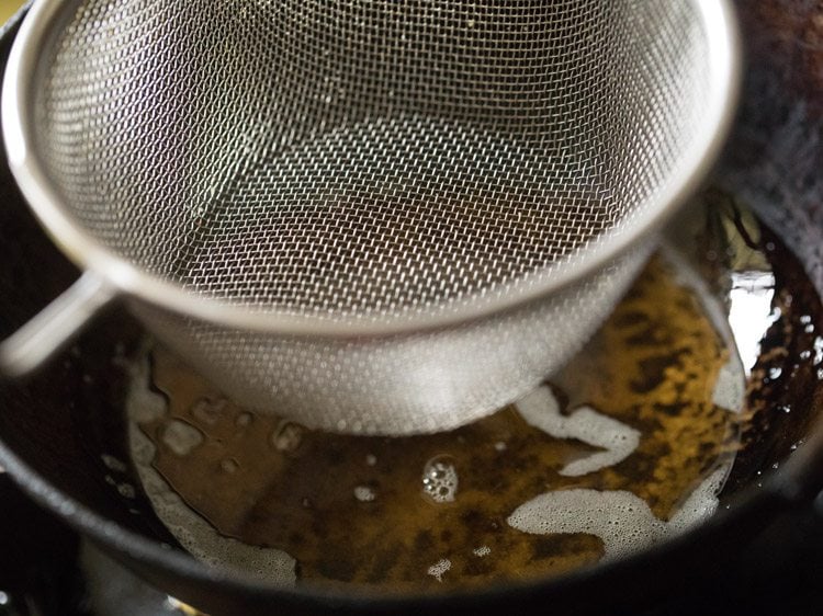 fine sieve ladle to fry ingredients for south indian mixture recipe. 