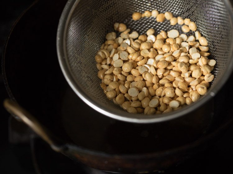 fried chana dal in the sieve ladle. 