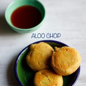 aloo chop served on a green colored plate with a small green colored bowl of sweet tamarind chutney kept on the top left side and text layovers.