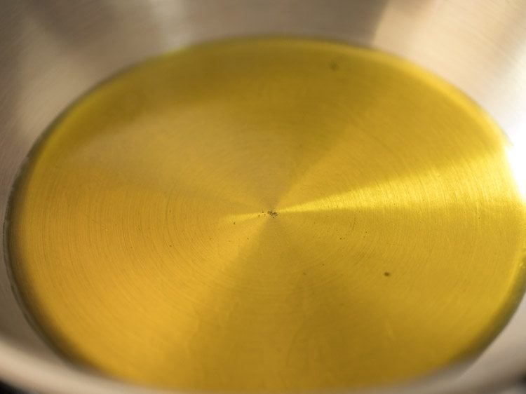 heating mustard oil in a pan. 