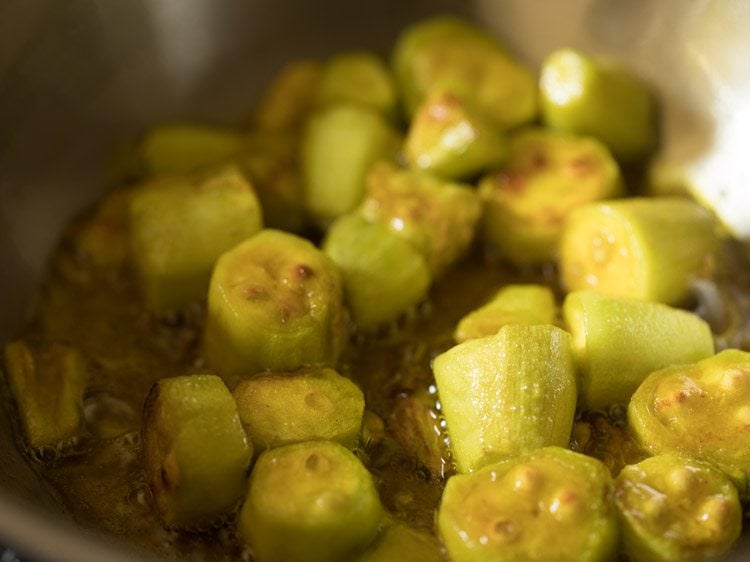 frying pointed gourd pieces till light golden. 