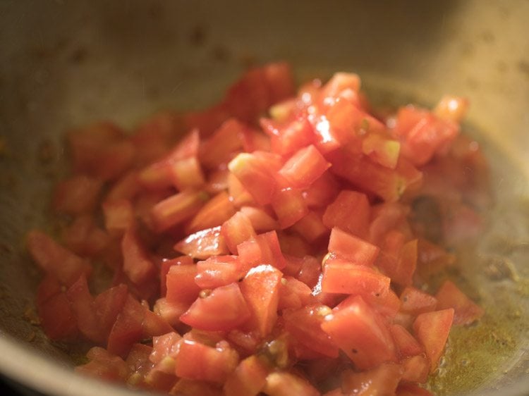 finely chopped tomatoes added to the oil. 