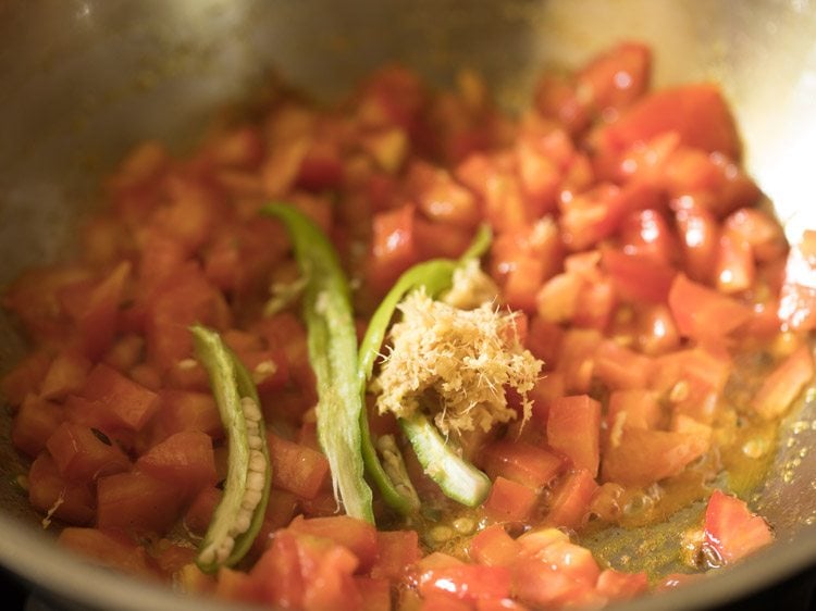 slit green chili and minced ginger added to the tomatoes in the pan. 