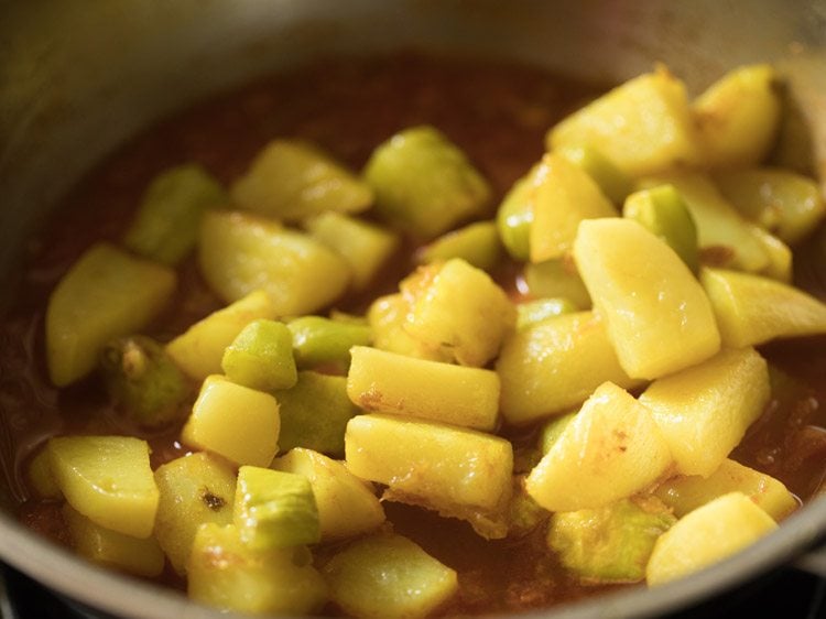 fried pointed gourd pieces and potato cubes added in the tomato curry. 