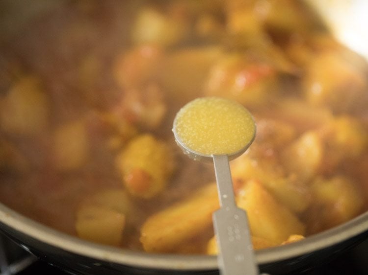 adding ghee in the potol recipe. 