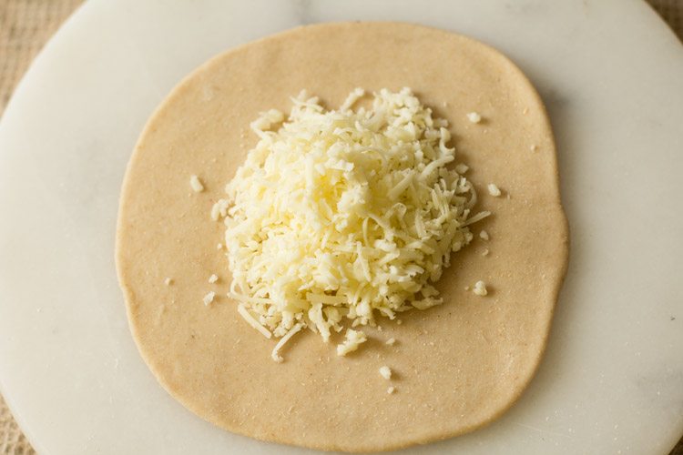 grated cheese added in the center of the disc. 